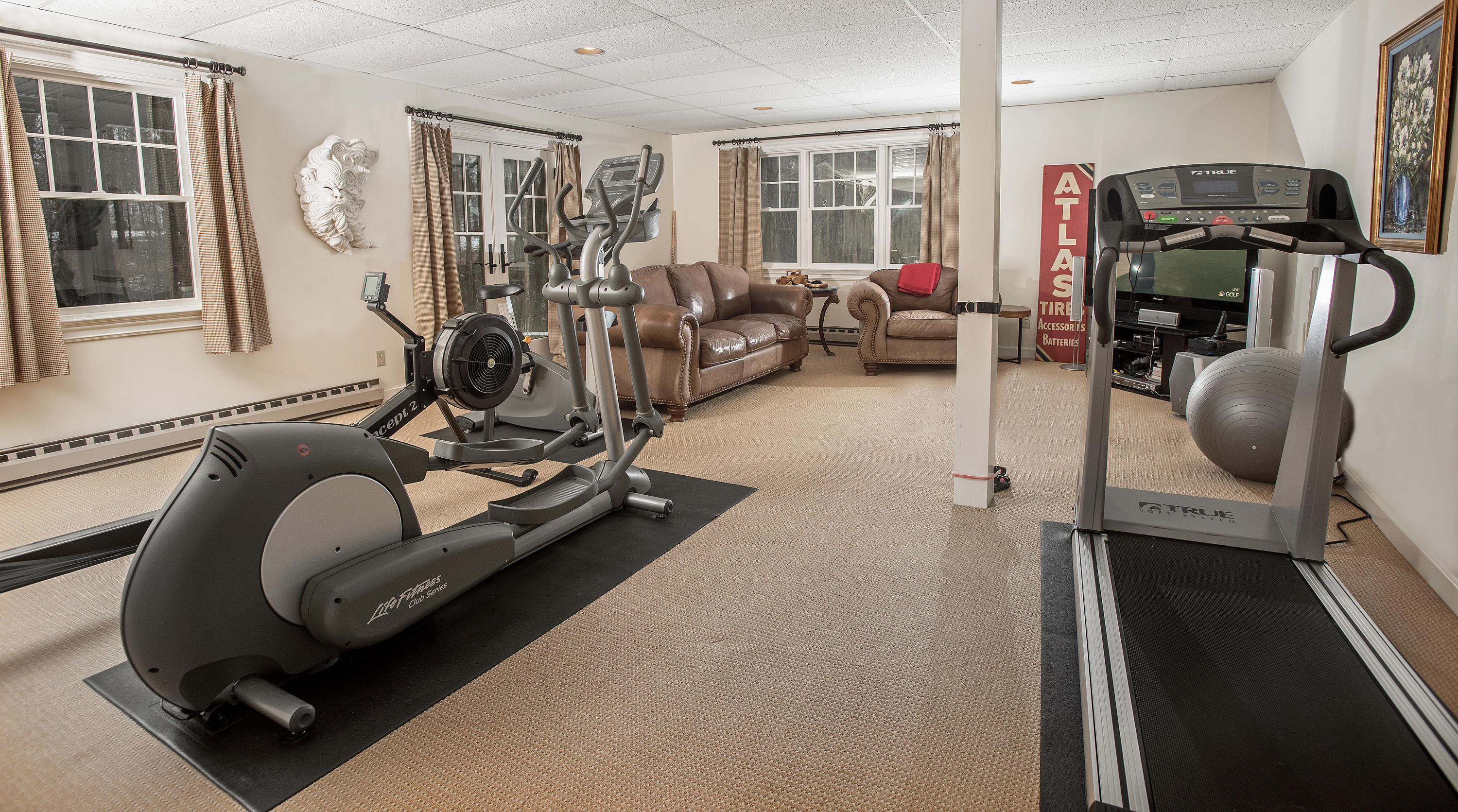 130 Skyview Lane New Canaan, CT 06840 - Photo 41 of 44 a room with gym equipment and windows