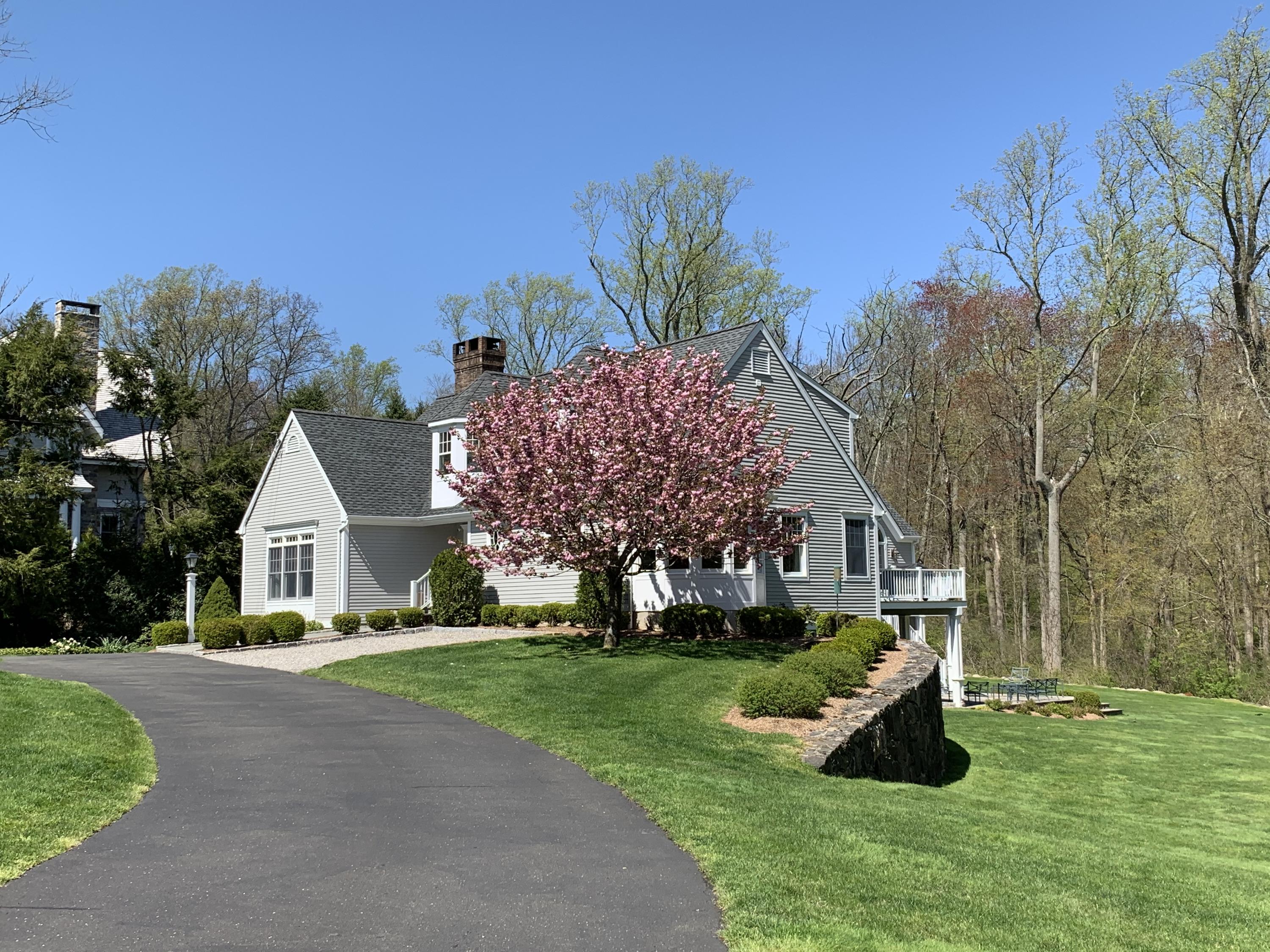 130 Skyview Lane New Canaan, CT 06840 - Photo 44 of 44 a view of a house with a big yard and large trees