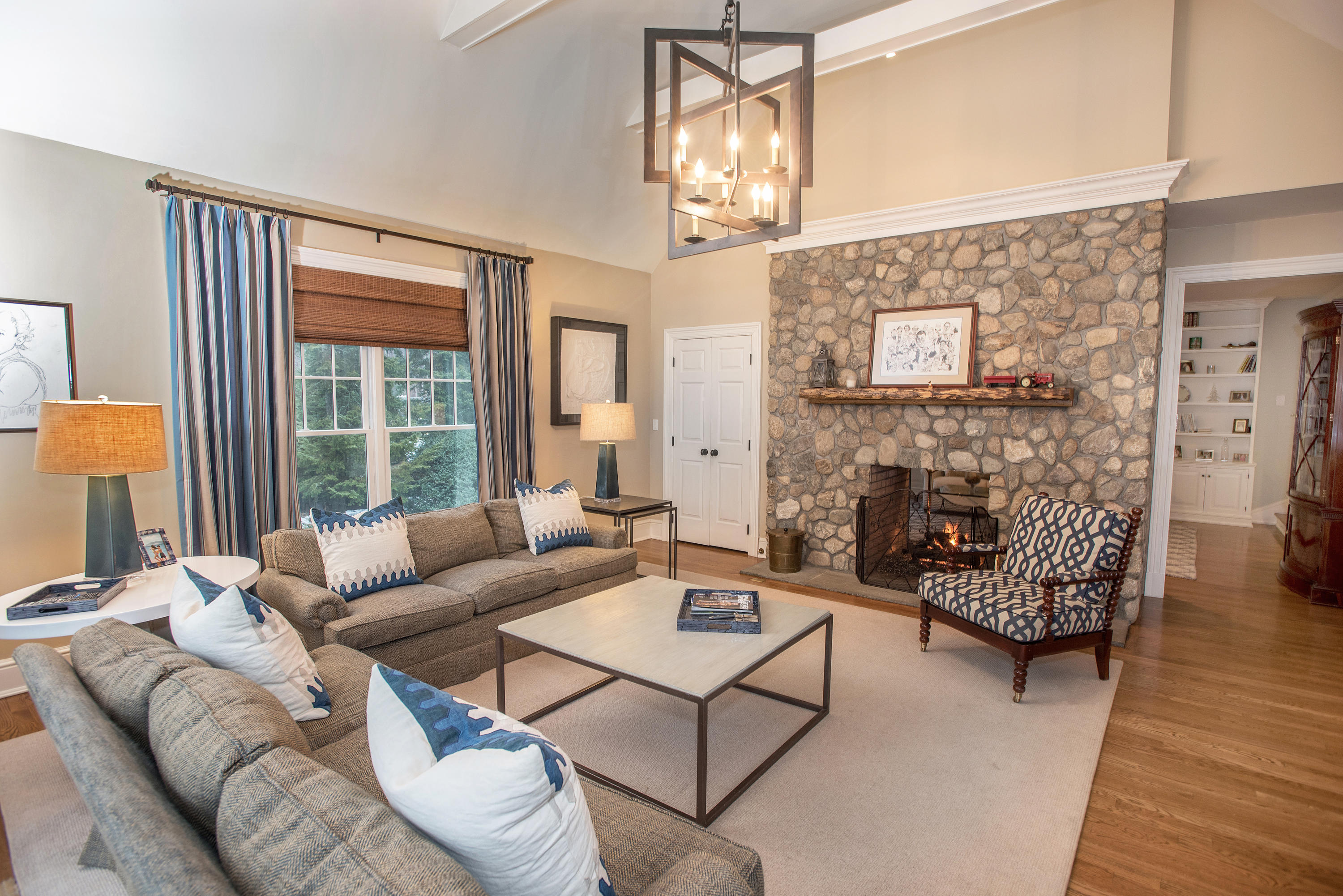 130 Skyview Lane New Canaan, CT 06840 - Photo 9 of 44 a living room with furniture a fireplace and a large window