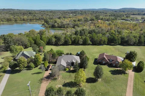an aerial view of a houses with outdoor space and lake view