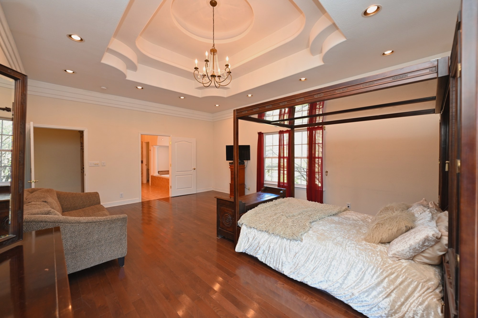 222 Ridgewater Way Mount Juliet, TN 37122 - Photo 14 of 41 a bedroom with a large bed and a chandelier