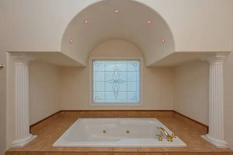 a bathroom with a tub and a window