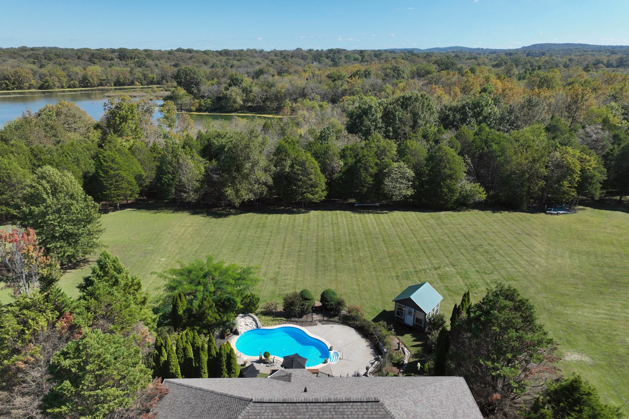 222 Ridgewater Way Mount Juliet, TN 37122 - Photo 2 of 41 a view of a lake with a yard and mountain in the back