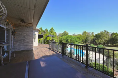 a view of balcony with wooden floor and outdoor seating