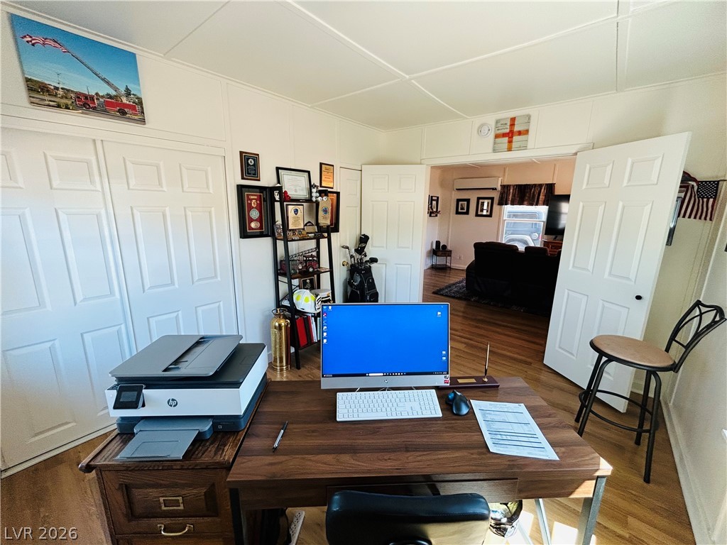 116 West Basic Road Henderson, NV 89015 - Photo 14 of 39 An inviting home office with ample storage, featuring durable hardwood flooring and convenient access to an adjacent living space.