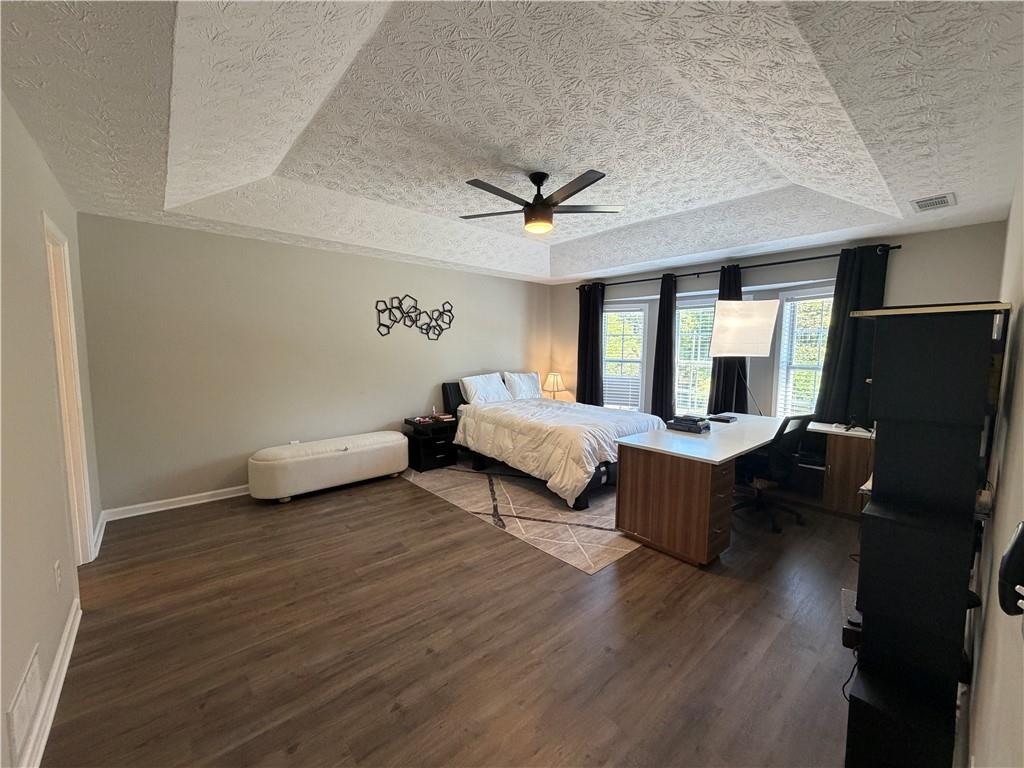934 Bay Ridge Drive Lawrenceville, GA 30045 - Photo 51 of 78 a bedroom with a bed and a chandelier