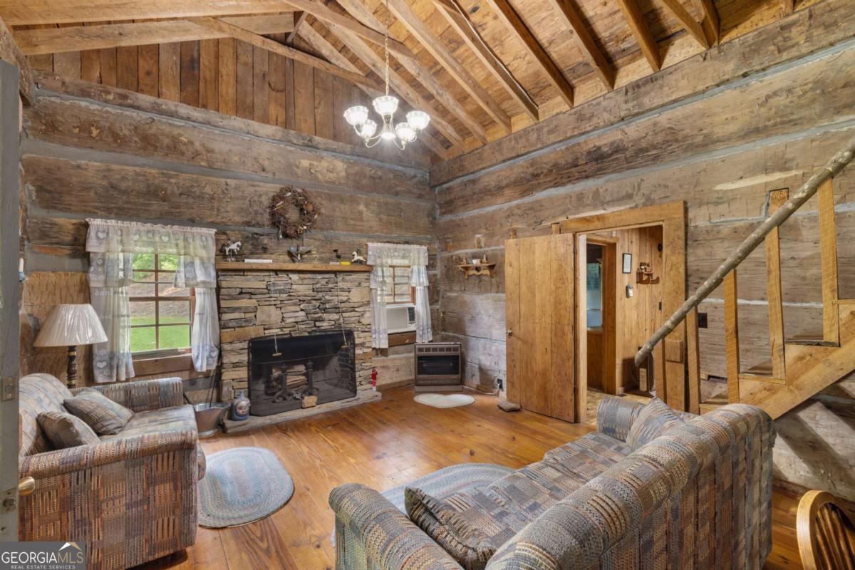 7320 Chestnut Valley Road Hiawassee, GA 30546 - Photo 29 of 91 a living room with furniture and a fireplace