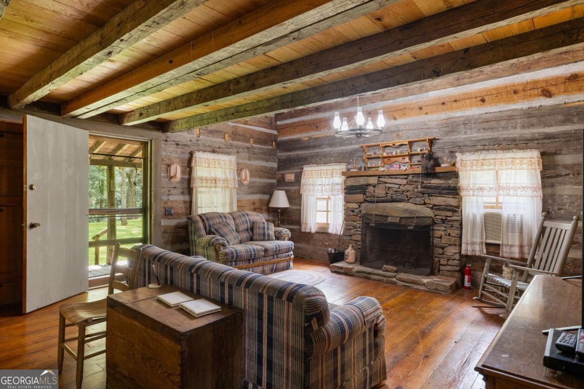 7320 Chestnut Valley Road Hiawassee, GA 30546 - Photo 54 of 91 a living room with furniture and a fireplace