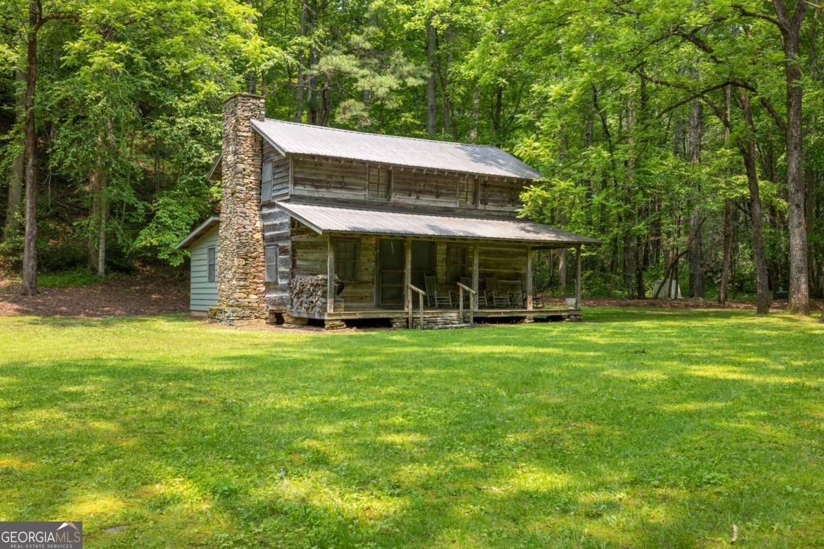 7320 Chestnut Valley Road Hiawassee, GA 30546 - Photo 58 of 91 a front view of a house with a garden