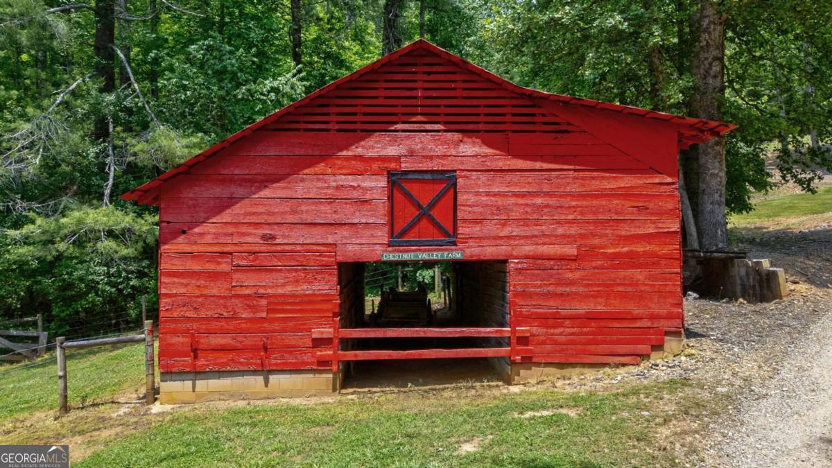 7320 Chestnut Valley Road Hiawassee, GA 30546 - Photo 68 of 91 a front view of a house with a garden