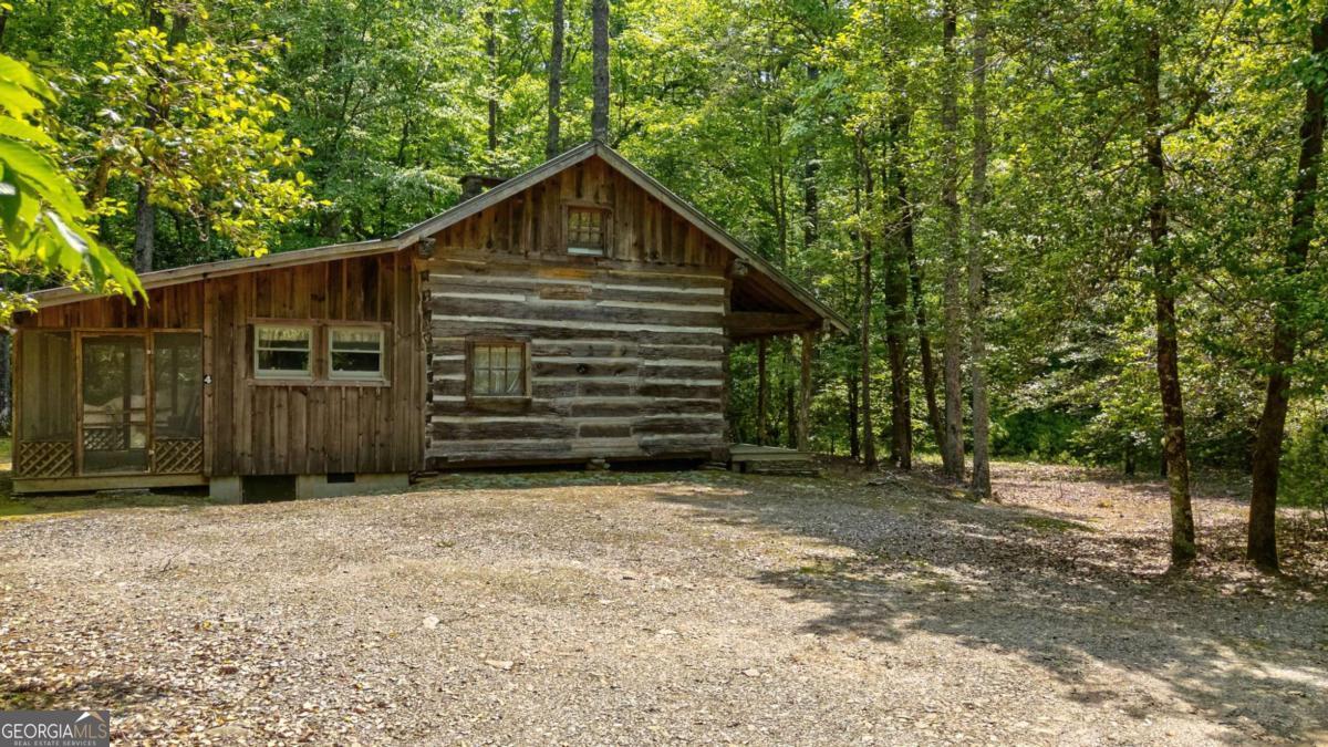 7320 Chestnut Valley Road Hiawassee, GA 30546 - Photo 80 of 91 a view of a house with a small yard and a large tree