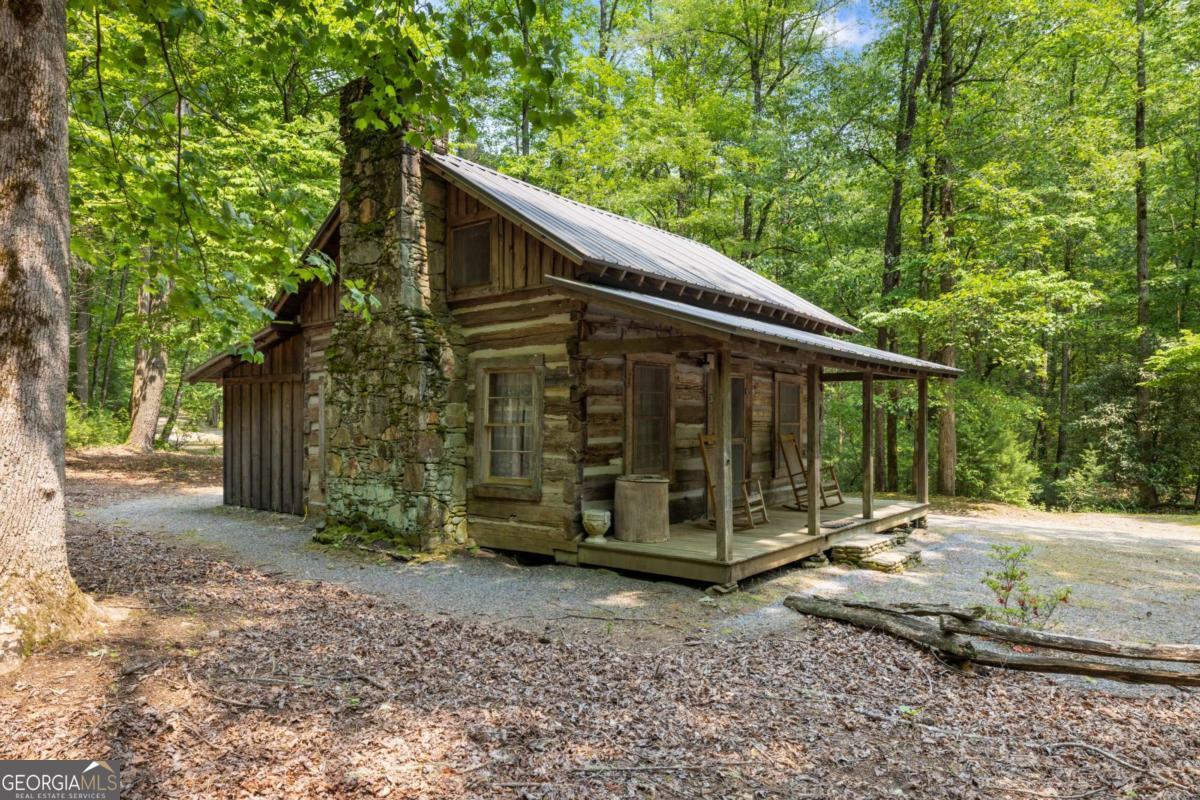 7320 Chestnut Valley Road Hiawassee, GA 30546 - Photo 84 of 91 a view of a barn in the backyard with large trees