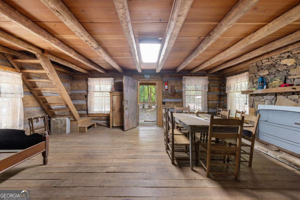 7320 Chestnut Valley Road Hiawassee, GA 30546 - Photo 85 of 91 a view of a dining room with furniture window and wooden floor