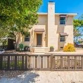 a front view of a house with a fence