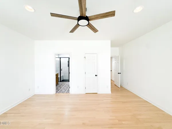 a view of a room with wooden floor and windows