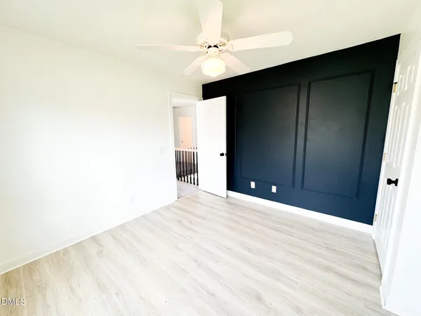 a view of an empty room with a ceiling fan
