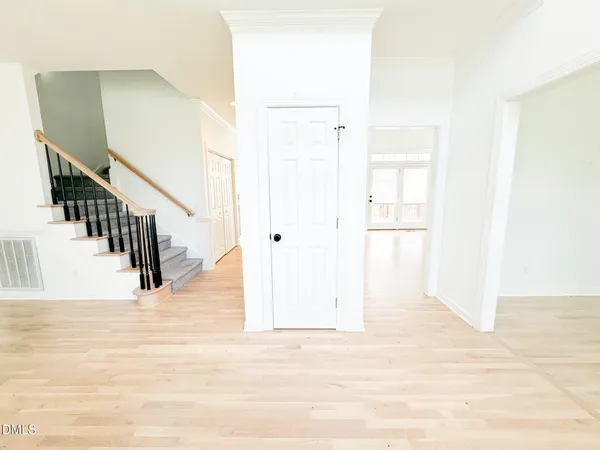 a view of entryway and hall with wooden floor