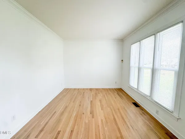 a view of a room with wooden floor and brick walls