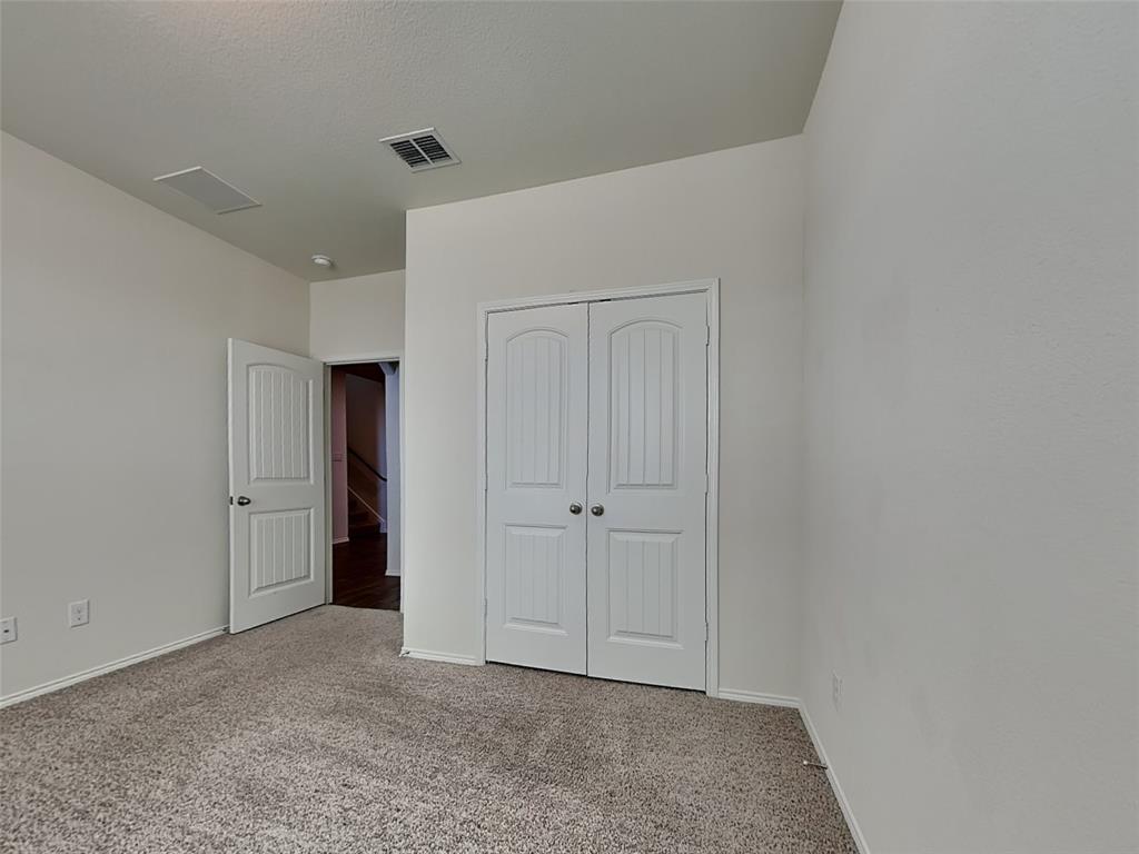 506 Robinson Way Fate, TX 75189 - Photo 14 of 30 Unfurnished bedroom featuring light carpet and a closet