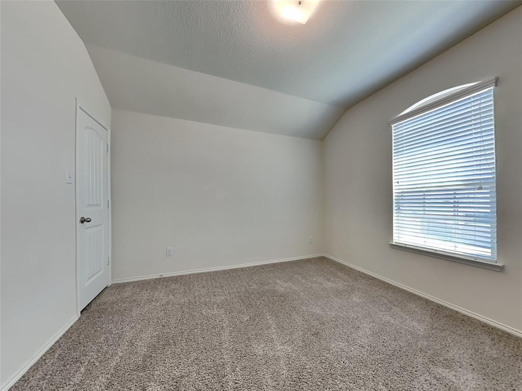 506 Robinson Way Fate, TX 75189 - Photo 16 of 30 Carpeted empty room featuring lofted ceiling and a textured ceiling