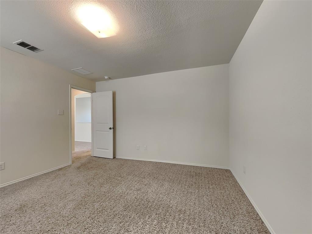 506 Robinson Way Fate, TX 75189 - Photo 18 of 30 Empty room with carpet and a textured ceiling