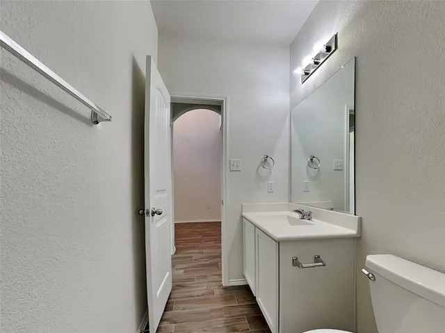 a spacious bathroom with a toilet a sink and mirror