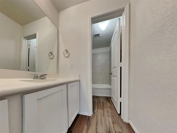 a white toilet sitting next to a bath tub