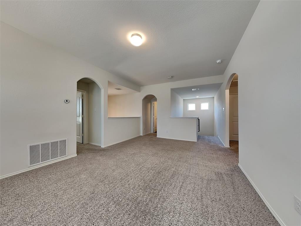506 Robinson Way Fate, TX 75189 - Photo 27 of 30 Spare room featuring arched walkways and light colored carpet