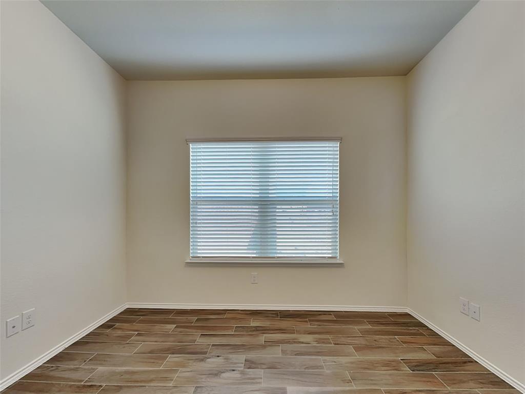 506 Robinson Way Fate, TX 75189 - Photo 7 of 30 Unfurnished room with wood tiled floors and baseboards