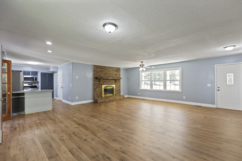 104 Doyle Drive Seneca, SC 29678 - Photo 4 of 19 This expansive great room seamlessly connects living and kitchen spaces, featuring a cozy fireplace and durable flooring.