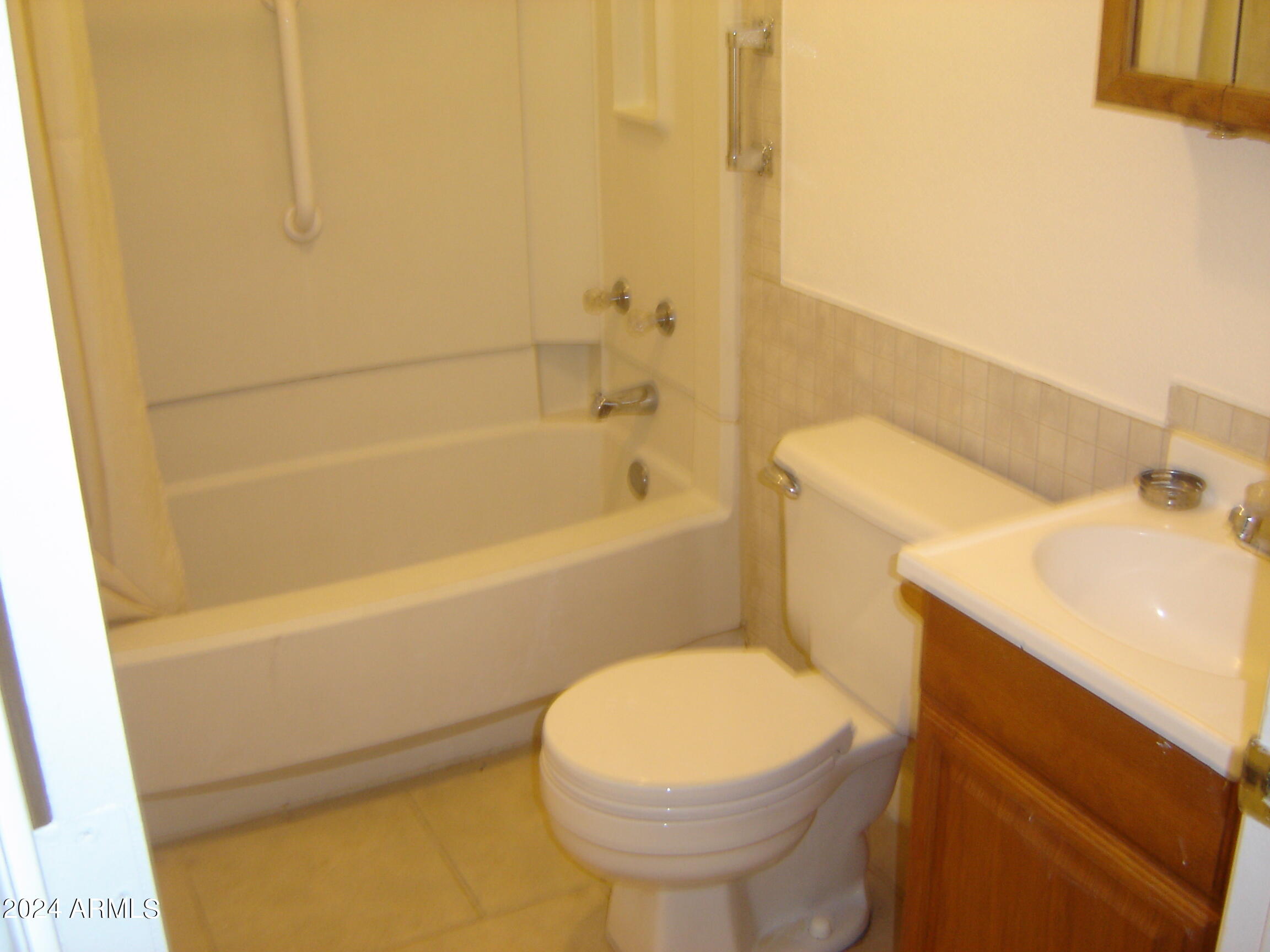 450 Palm Drive, Unit 4 Wickenburg, AZ 85390 - Photo 4 of 7 a bathroom with a sink and a toilet