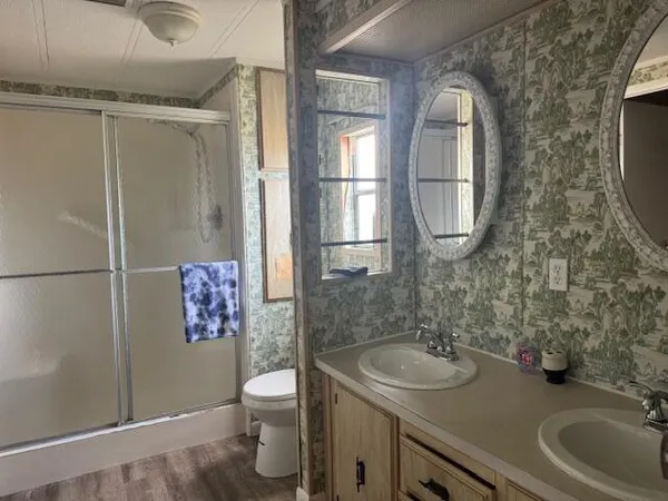 a bathroom with a sink toilet and shower
