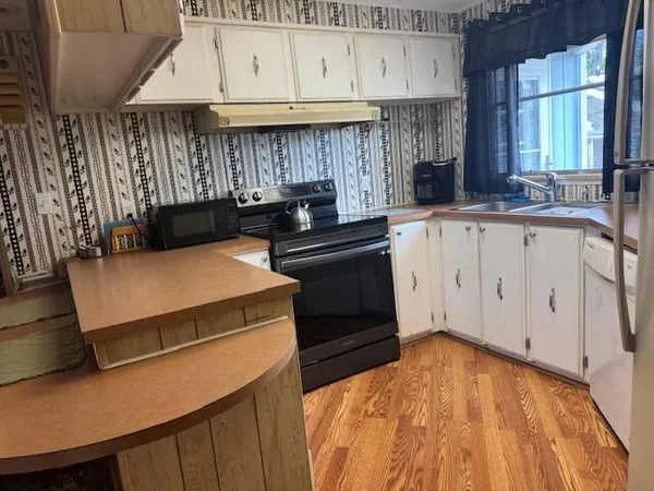 a kitchen with a stove and a sink