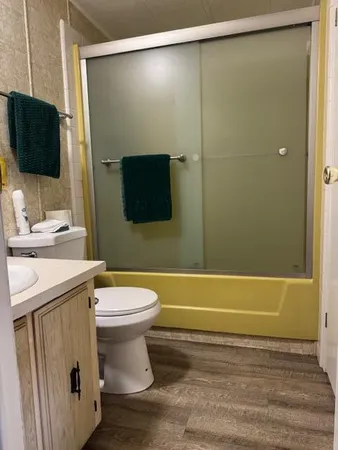 a bathroom with a sink a toilet and a mirror