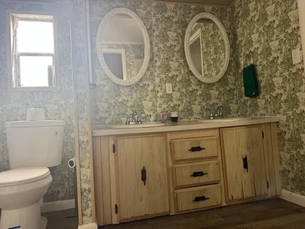 a bathroom with a toilet and a mirror