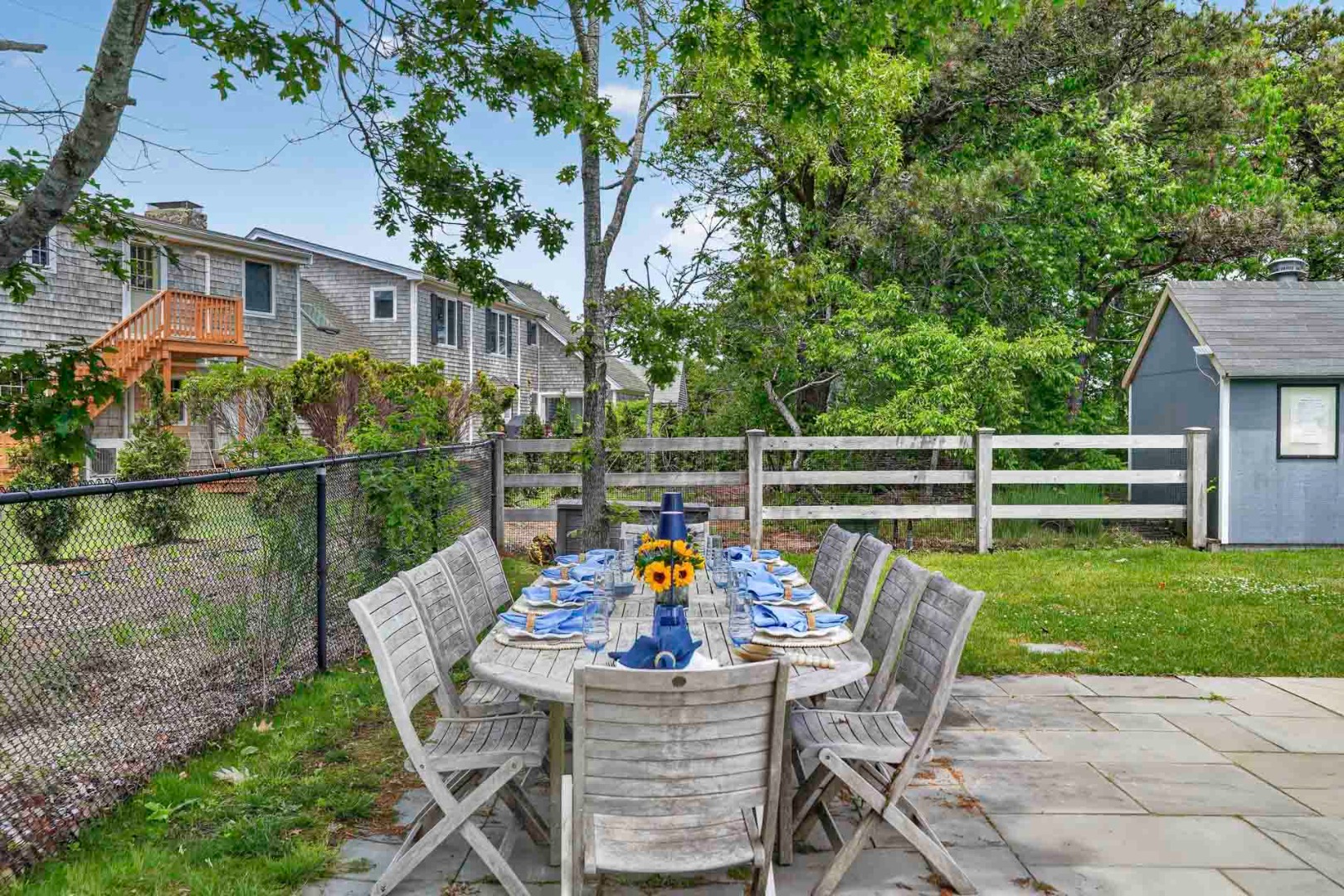 9 Thaxter Lane Edgartown, MA 02539 - Photo 49 of 53 a view of a chairs and table in the patio next to a yard