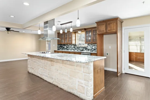 a spacious bathroom with a granite countertop sink a mirror and shower