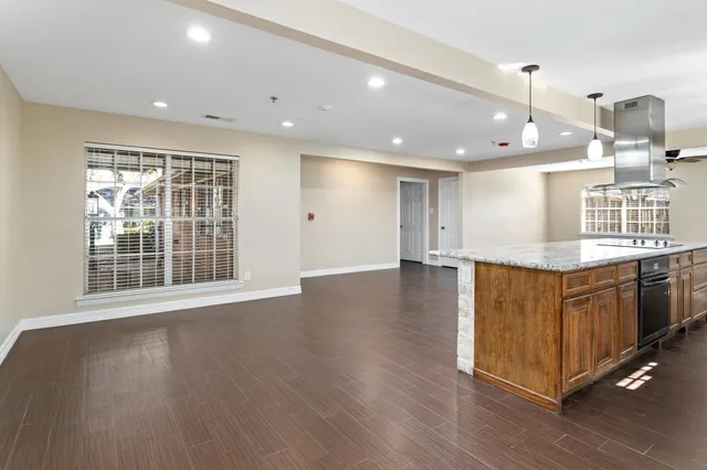 a view of kitchen with wooden floor and windows