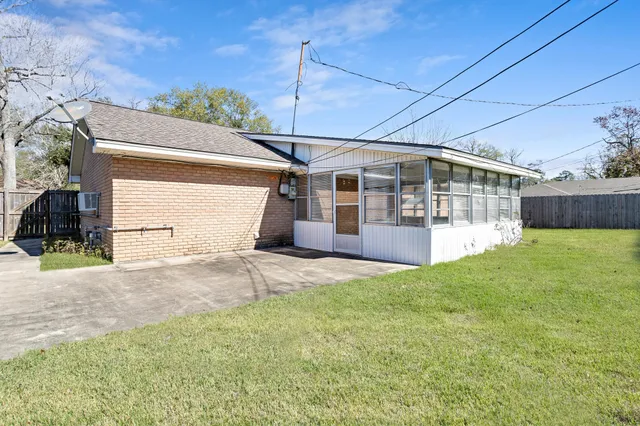 a view of a house with a backyard and a garage