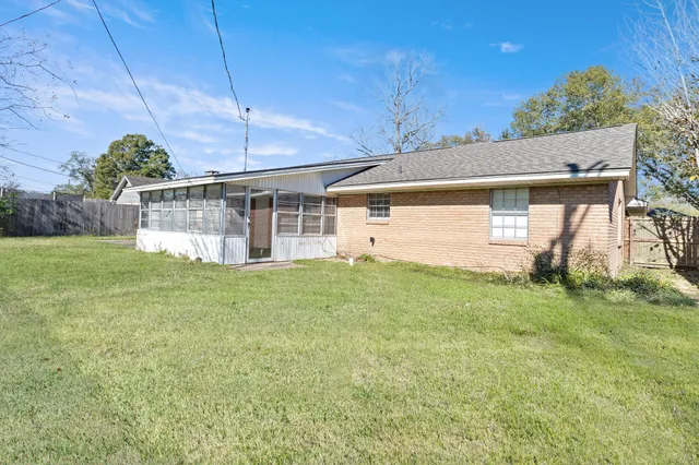 a view of a backyard with plants and a garden