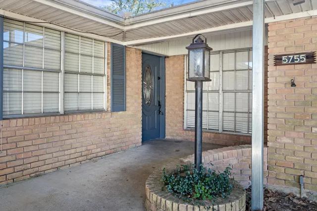 a porch with a glass door shower