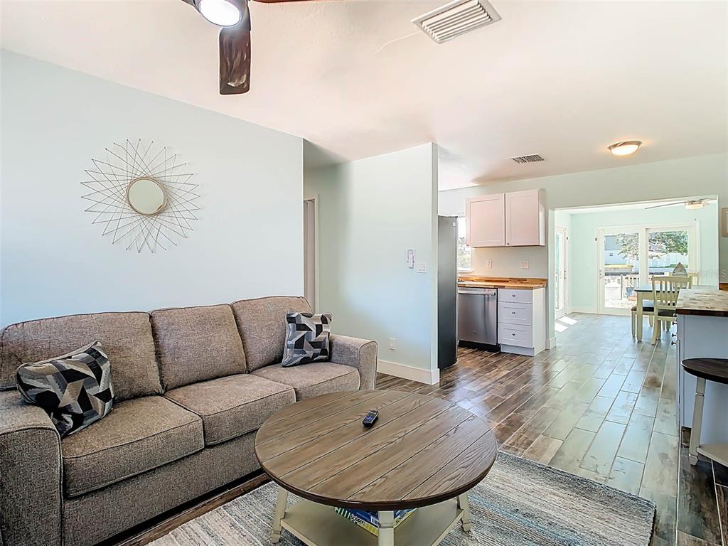 4984 Cedarbrook Lane Hernando Beach, FL 34607 - Photo 12 of 61 a living room with furniture and a wooden floor