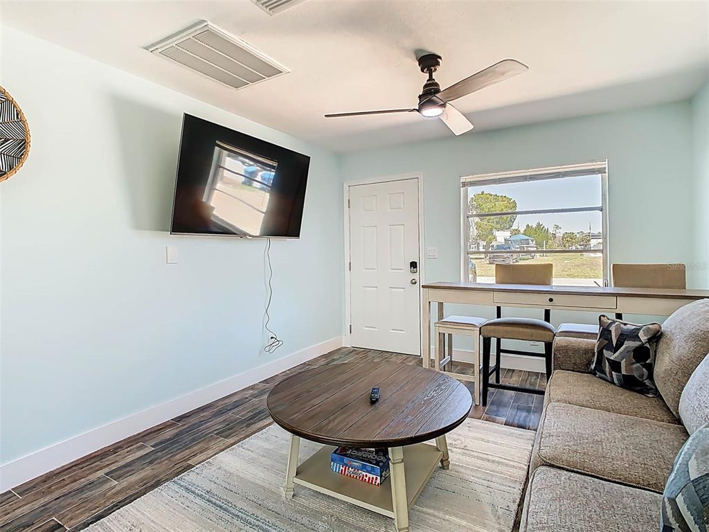 4984 Cedarbrook Lane Hernando Beach, FL 34607 - Photo 15 of 61 a living room with furniture and a flat screen tv