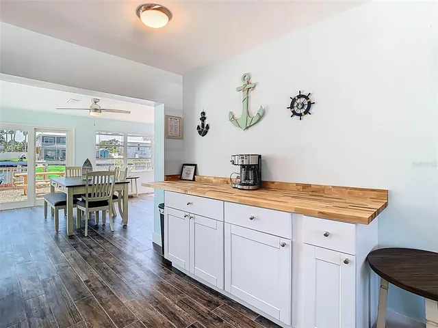 a kitchen with granite countertop a sink and a stove with wooden floor