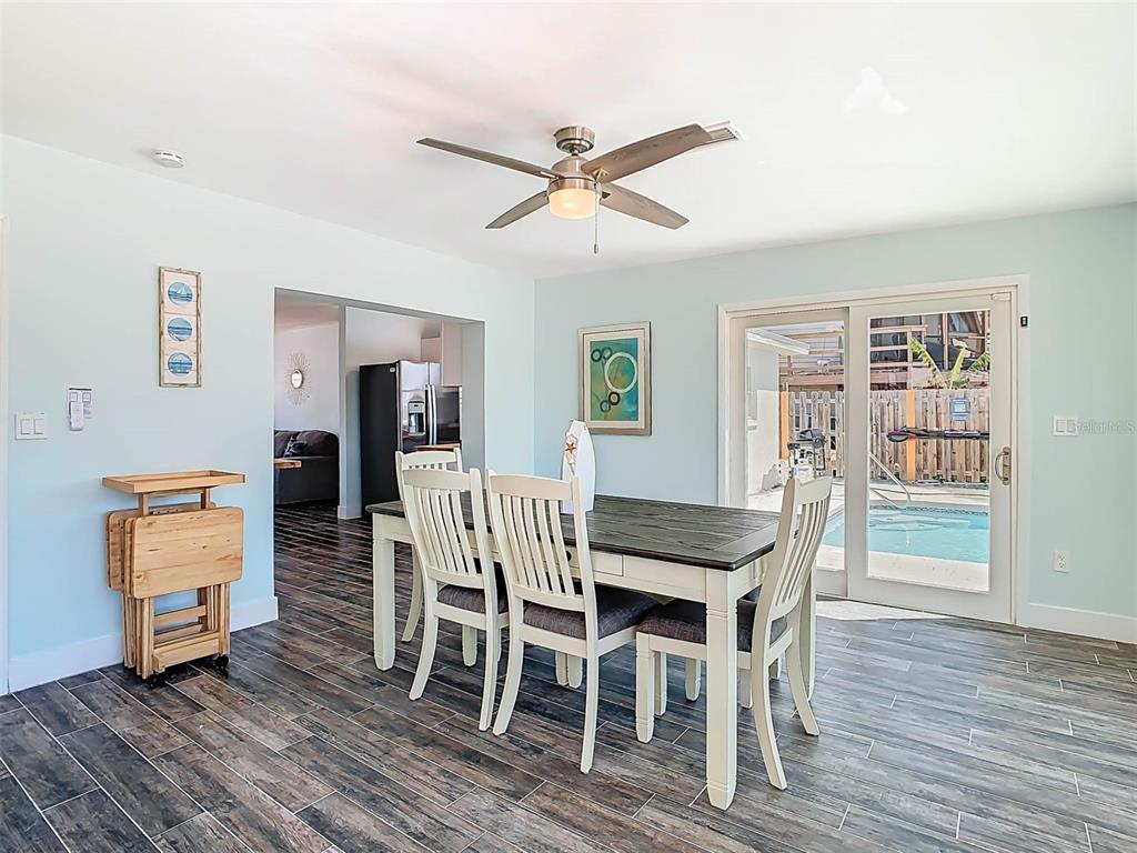 4984 Cedarbrook Lane Hernando Beach, FL 34607 - Photo 26 of 61 a view of a dining room with furniture and wooden floor