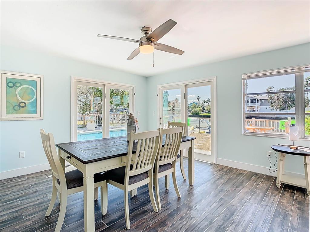4984 Cedarbrook Lane Hernando Beach, FL 34607 - Photo 27 of 61 a view of a dining room with furniture window and wooden floor