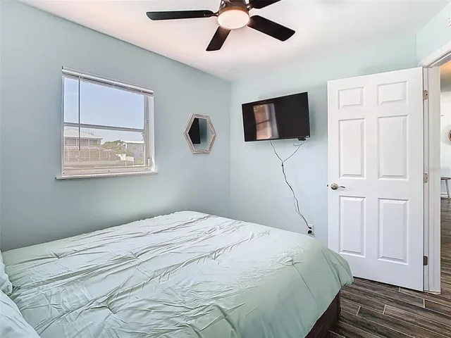 a bedroom with a bed and a flat screen tv