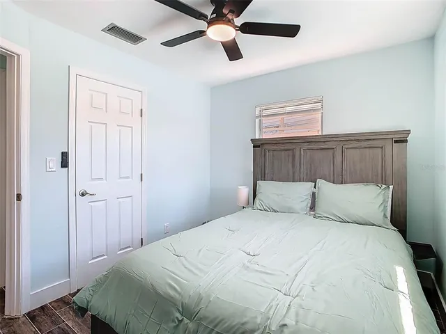 a bedroom with a large bed and a flat screen tv