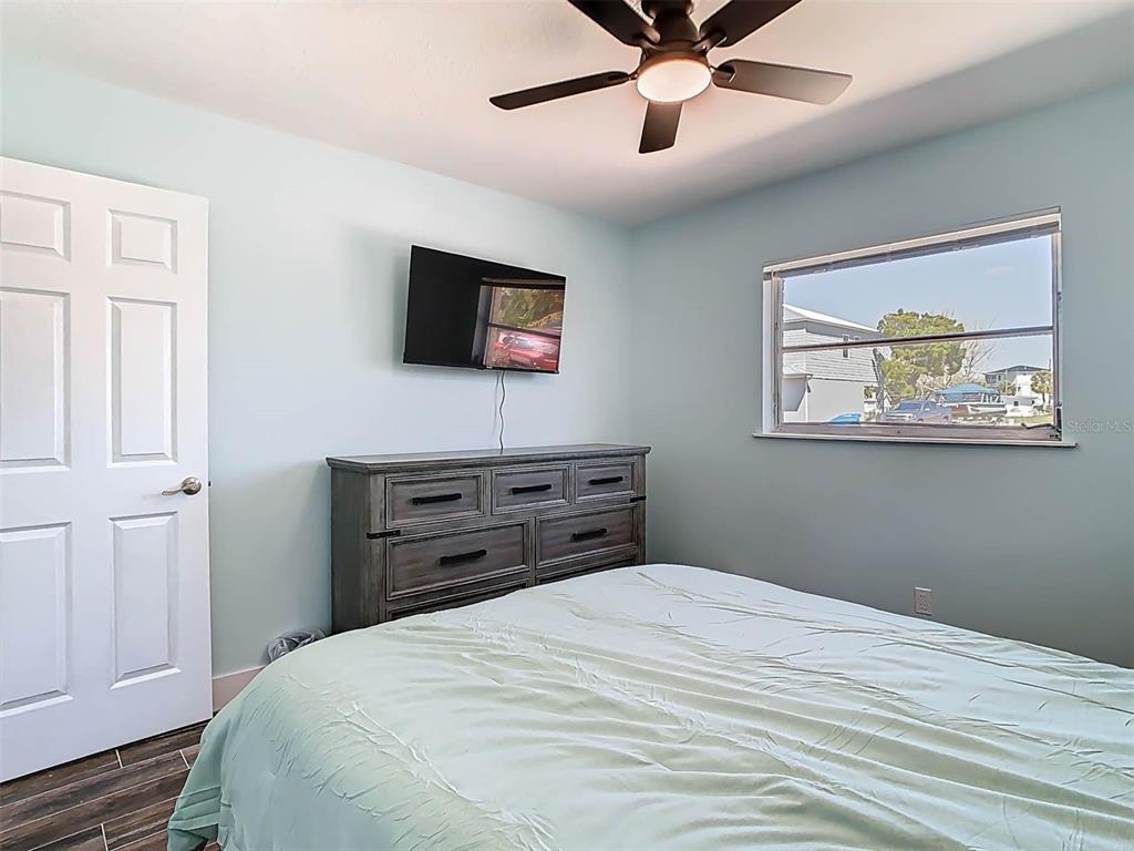 4984 Cedarbrook Lane Hernando Beach, FL 34607 - Photo 38 of 61 a bedroom with a bed and a flat screen tv