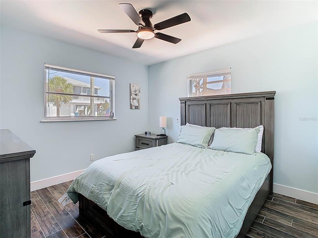 4984 Cedarbrook Lane Hernando Beach, FL 34607 - Photo 39 of 61 a bedroom with a large bed and a chandelier